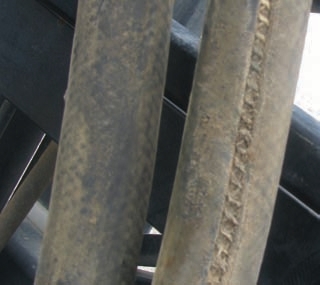 These photos show hoses worn from rubbing. Even covers might not protect underlying hose layers as shown in the photo of the orange hose.