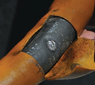 These photos show hoses worn from rubbing. Even covers might not protect underlying hose layers as shown in the photo of the orange hose.