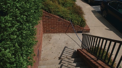 Running hoses over sidewalks or other high-traffic areas can damage the hoses or injure people who might trip over them.