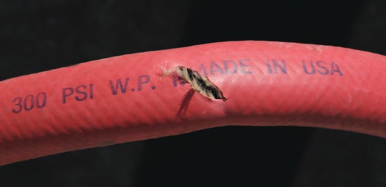 The red hose shows sign of bursting under too much pressure.