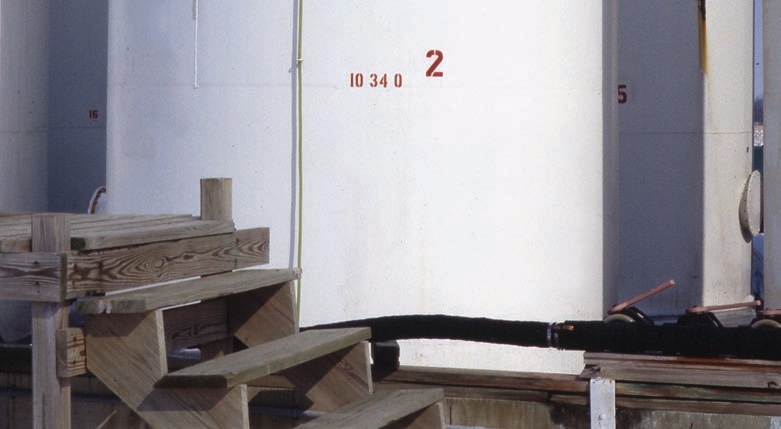 The clear hoses on these tanks gauge the level of fluid they contain. Only open the valve to these hoses when you want to check the level in the tank. If the hose fails when the valve is open, some or all of the tank’s contents can be spilled.
