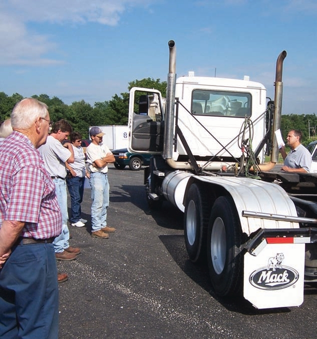 A mechanic reviews with growers what is required in a U.S. DOT vehicle inspection.