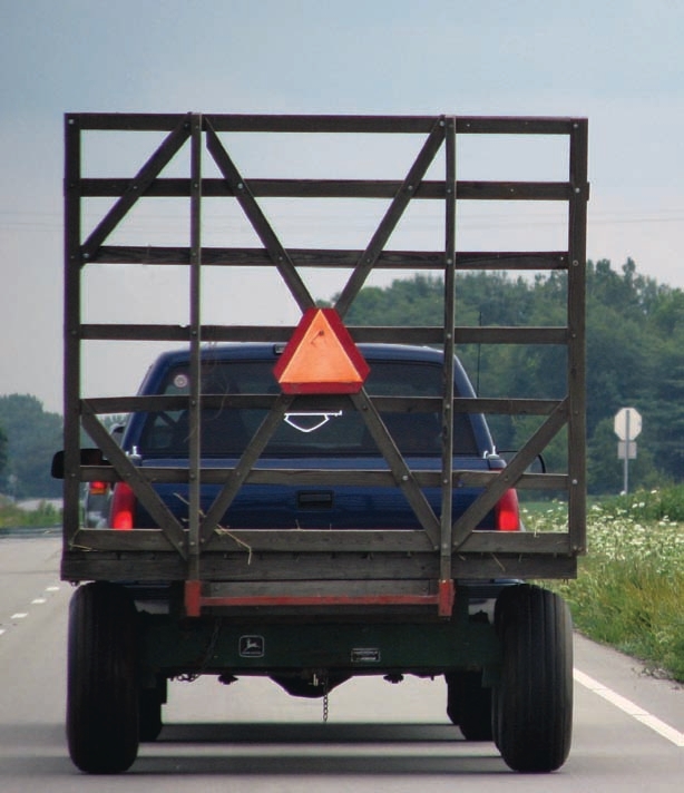 Slow-moving vehicle signs warn other drivers on the road. Not having such signs could pose a legal risk in the event of an accident.