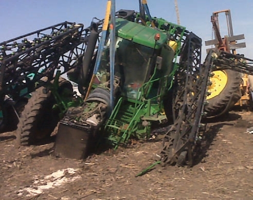 The driver of this sprayer drove through a stop sign and collided with a truck.