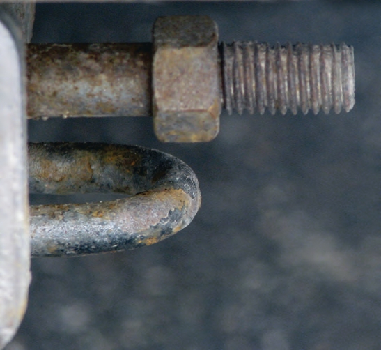 This photo shows good and bad practices. A single nut can easily come loose. However, the bolt is solid and the weaker threads are away from the stress.
