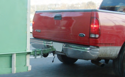 This truck is pulling a trailer without safety chains.