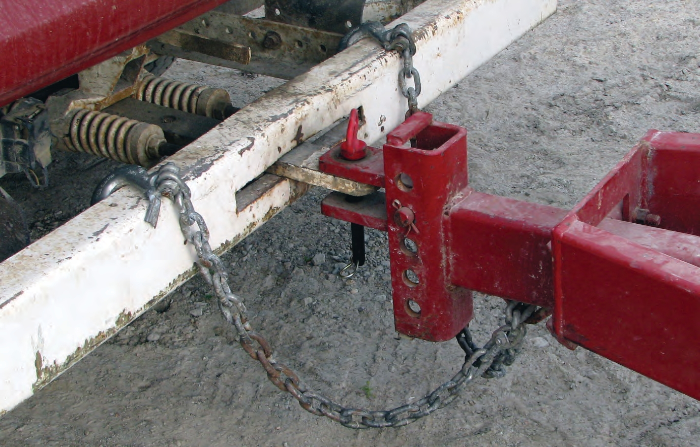 On the left side of this bumper, you can see that the driver broke off the spring-loaded backs of the hooks on the safety chain.