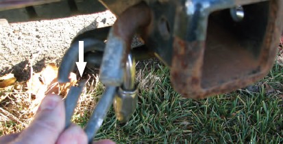 This connector is not made to withstand the pressure of a safety chain pulling against it. Notice that the open area between the two posts has little metal, which makes it a weak link at that point.