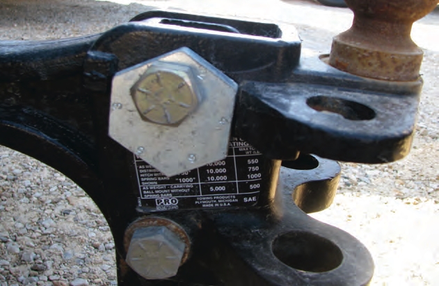 Use grade 5 or 8 bolts to attach safety chains to frames. Note the six lines on the bolt head that signify this is a grade 8 bolt.