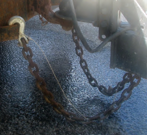 This emergency trailer brake cable is improperly hooked to the chain.