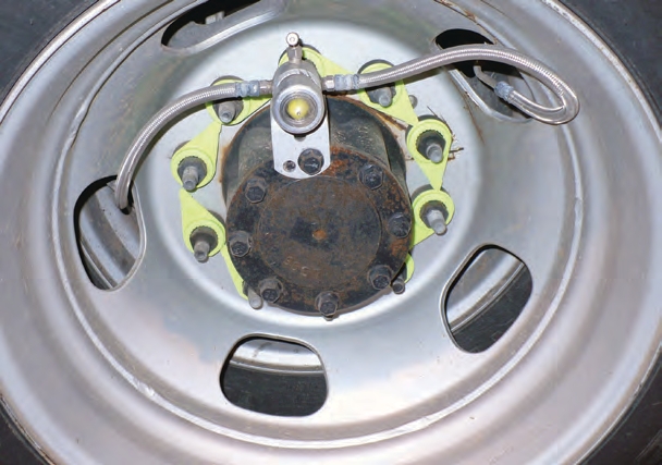 The yellow markings on this trailer wheel are lug nut indicators. If an arrow is not facing the same direction as the others, that indicates the nut is loose.