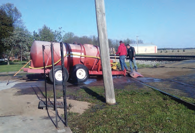 When this fertilizer trailer crossed railroad tracks it pulled the bumper off the truck.