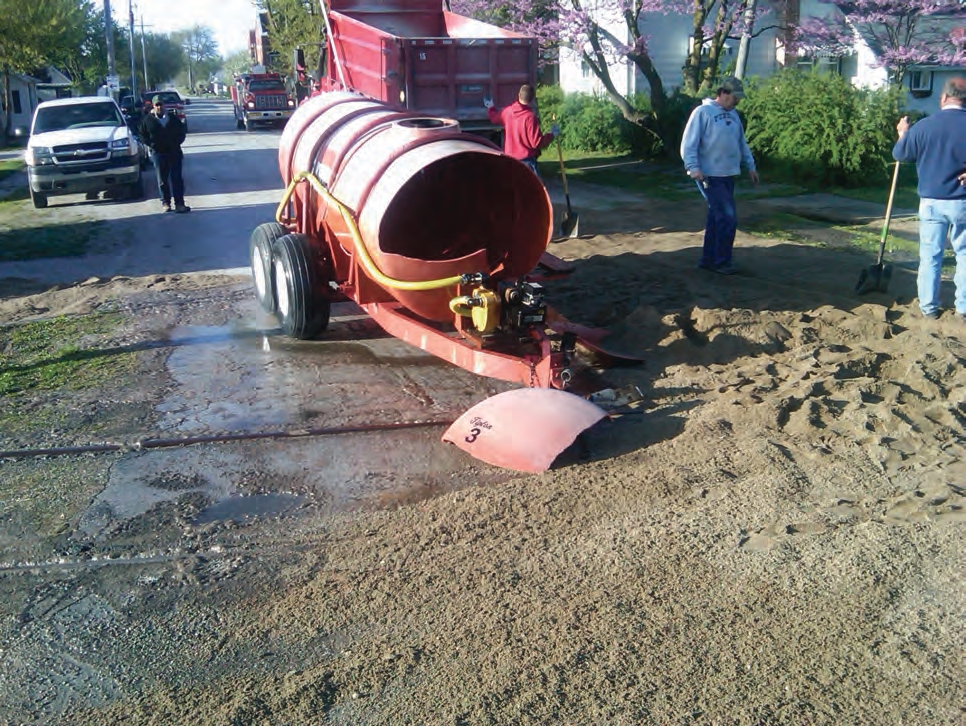 The trailer tongue hit the tracks, causing the fertilizer to push forward, and the front of the poly tank collapsed.