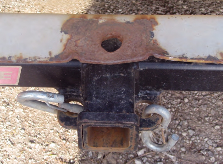 Never modify a bumper by cutting a larger opening. It weakens the bumper and reduces the weight it can tow.
