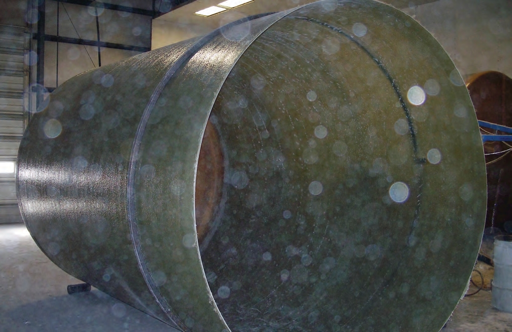 This fiberglass tank has been removed from its mold. A removable steel ring placed near the opening where the top will eventually be prevents the open end from collapsing.