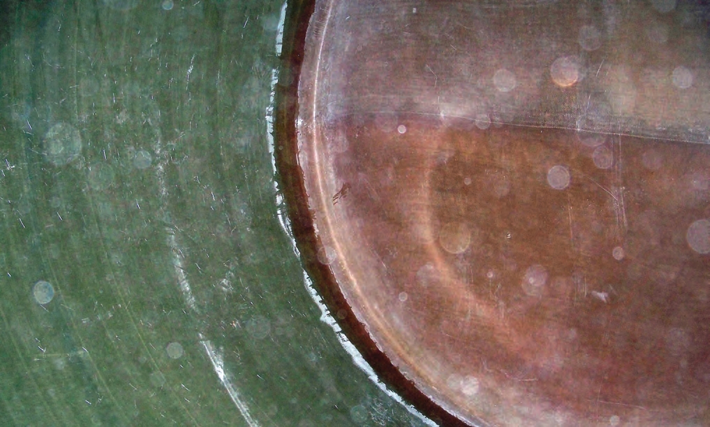 This photo shows the bottom of the tank. Some manufacturers apply a fiberglass mat by hand around the seam that is created where the sidewall is placed into the bottom (appears as a dark brown ring around the seam).