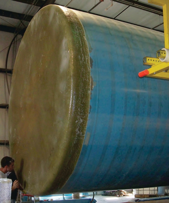 The manufacturer places a tank bottom on a mold (also called a mandrel).