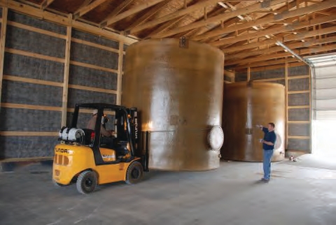 forklift or front-end loader to position the tank and place it upright once it is unloaded.