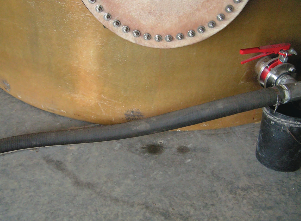 A small leak from this tank’s manway allows the contents to accumulate on the concrete.