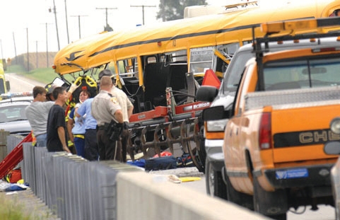 firefighters investigating a truck accident with a school bus