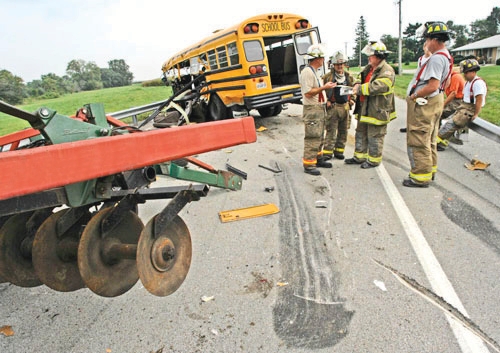 firefighters investigating a truck accident with a school bus