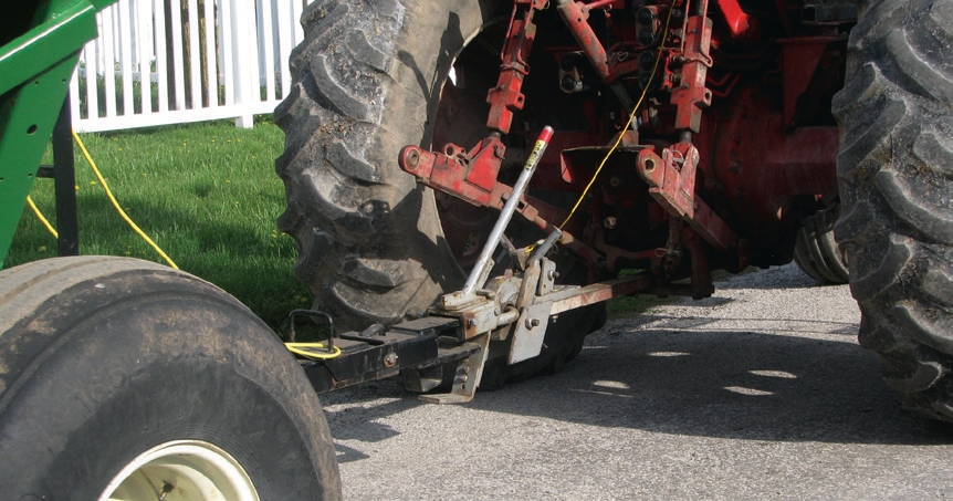 novel devices that allow the tractor and wagon to be connected and disconnected without the driver having to leave the cab.