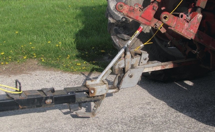 novel devices that allow the tractor and wagon to be connected and disconnected without the driver having to leave the cab.