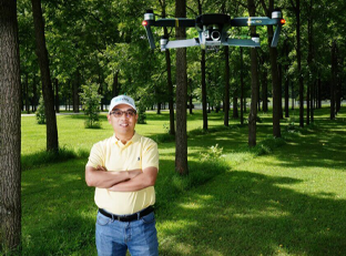 Dr. Songlin Fei pictured next to a drone