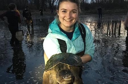 Morgan Sussman, wildlife student, holding turtle.