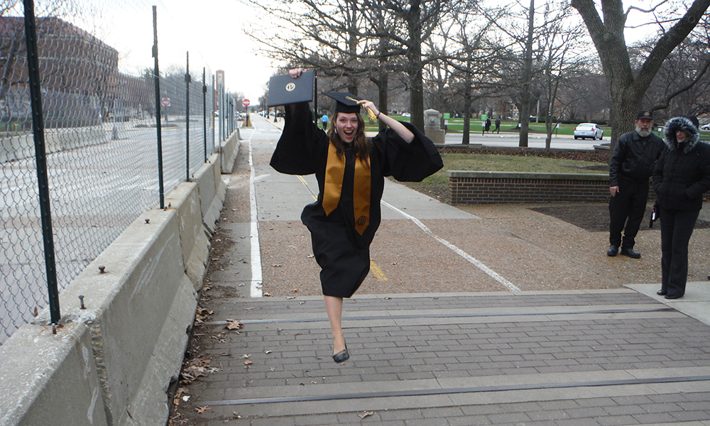 Rebecca Busse, wildlife sciences student, jumping in graduation gown for Purdue graduation day.