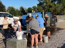 American Fisheries Society students volunteer to stock pond at Columbian Park Zoo, Lafayette.