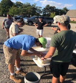 American Fisheries Society students volunteer to stock pond at Columbian Park Zoo, Lafayette.