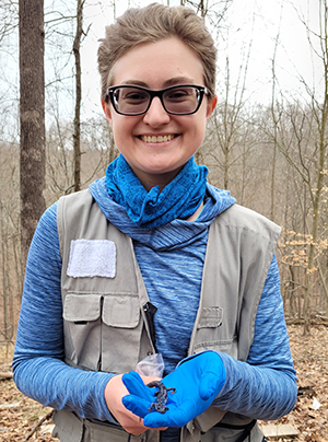 Researcher Alison Ochs holds a salamander