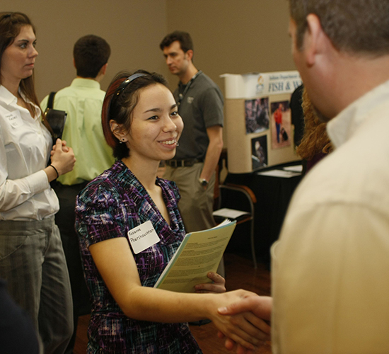 Student shaking hands with employer at FNR Career Fair.