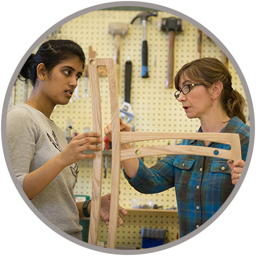 Wood Product Designers working on wooden built chair.