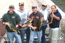 Students holding fish, Aquatic Ecology Research Lab.