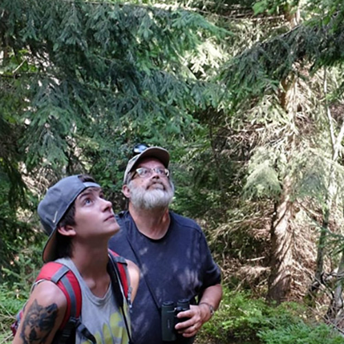 Dr. Barny Dunning with student in forest.