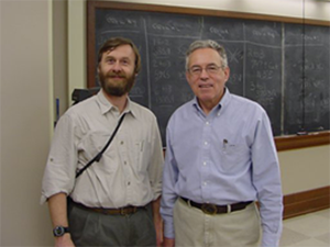 John Moser standing in classroom.