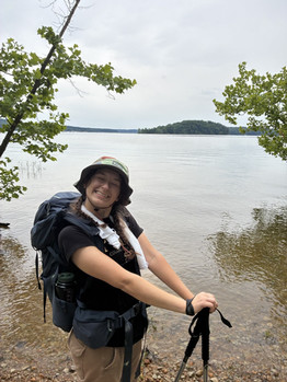 Addison “Addy” Ellis poses for a photo in front of a lake or pond.