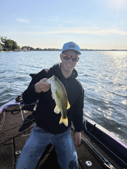 Collin Frost holds a fish.