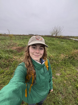 Reese Kent takes a selfie on a grassy field.