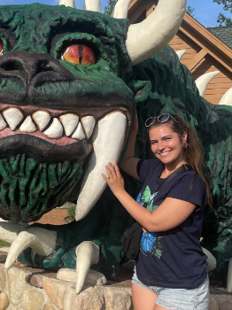 Zoe Crofton poses in front of a green animal statue.