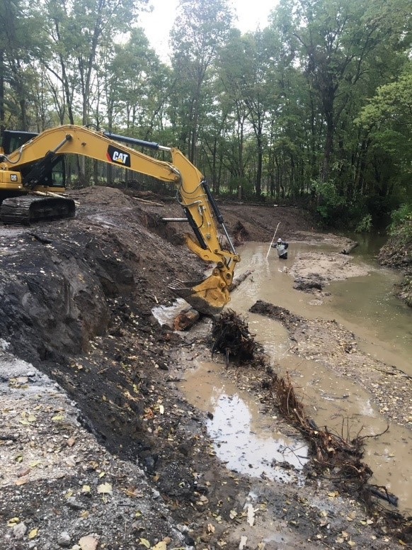 Crane working on retention wall for stream on Martell Forest.