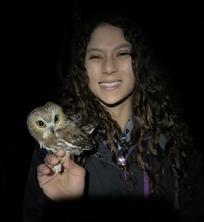 Tabitha Olsen holds a Northern Saw-whet Owl