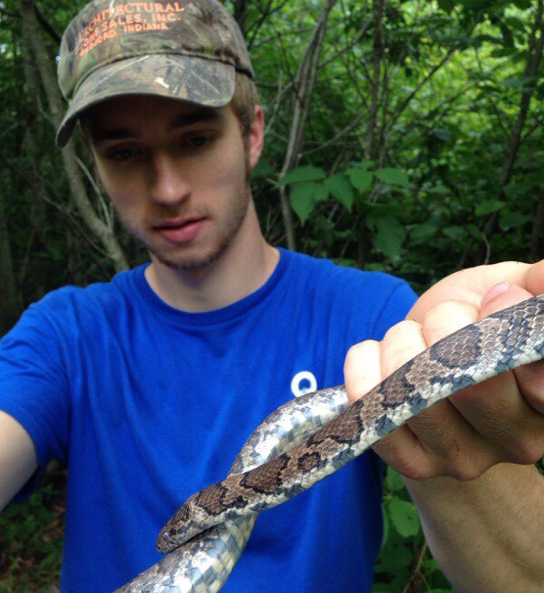 Student holding snake.