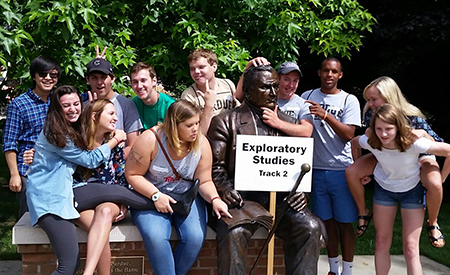 VSTAR, students taking photo with John Purdue statue on campus.