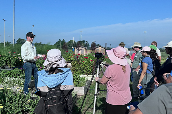 Group at gardens for outside workshop discussing soil contamination.