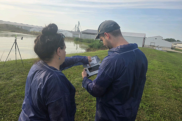 Students by pond conducting research on avian flu.