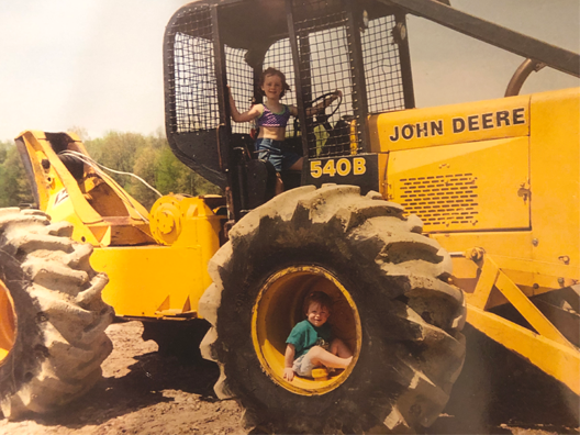 Sara High as a little girl on her dad's tractor.