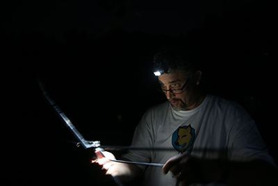 Pat Zollner monitors bats at night using telemetry equipment